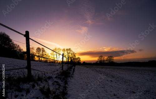 Sunset behind snowy Field © Martin Schmidt