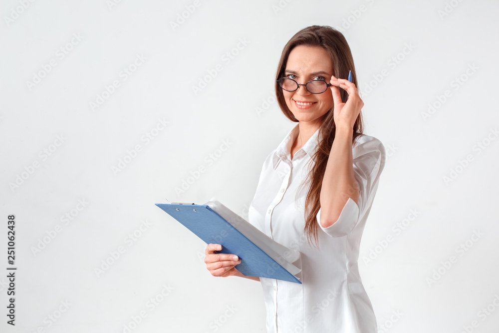 Business meeting. Woman in eyeglasses standing isolated on white with clipboard and pen preparing for negotiation smiling confident