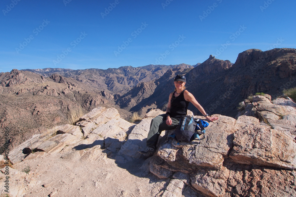 Woman enjoying expansive views at the end of the Blackett's Ridge Trail in the Santa Catalina Mountains near Tucson, Arizona.