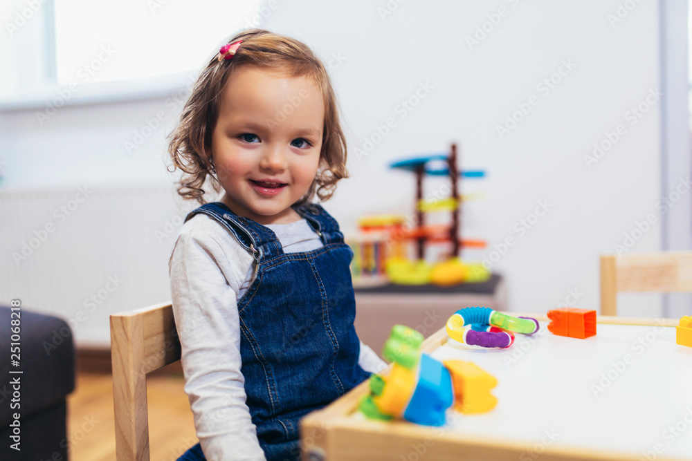 Cute child playing on table indoor, selective focus Cute child playing on table indoor, selective focus