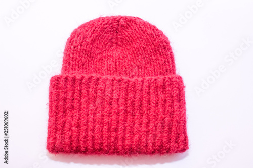 The bright pink knitted hat. White background.