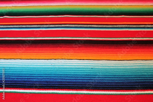 poncho Mexican cinco de mayo rug blanket serape fiesta traditional Mexico poncho background Mexican stripes copy space blanket minimal simple cinco de mayo serape pattern background  -  stock photo