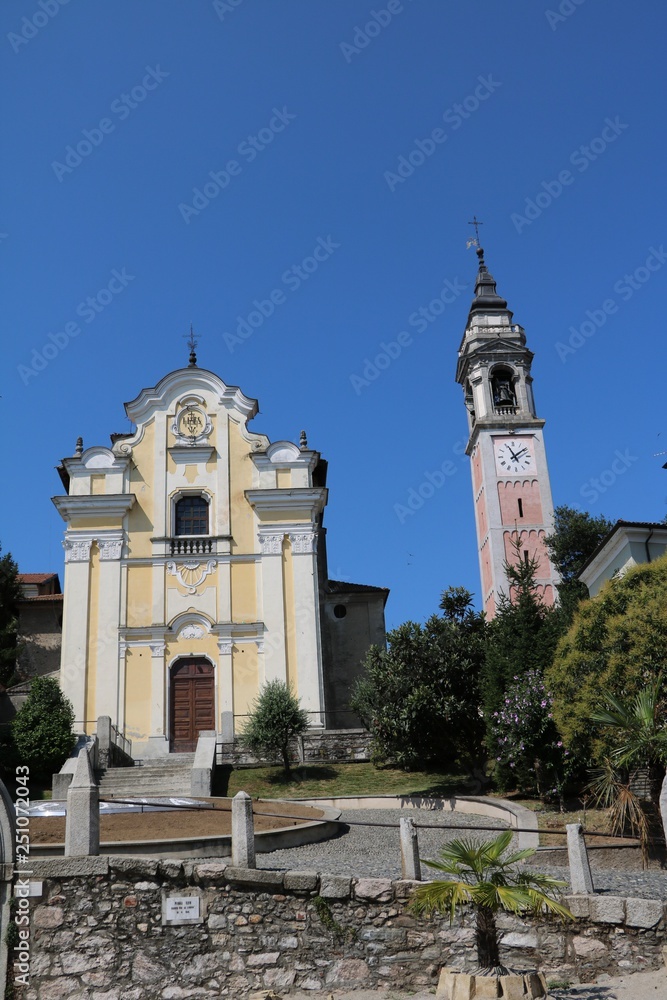 Church of martyrs and bell tower of collegiate church in Atona, Italy