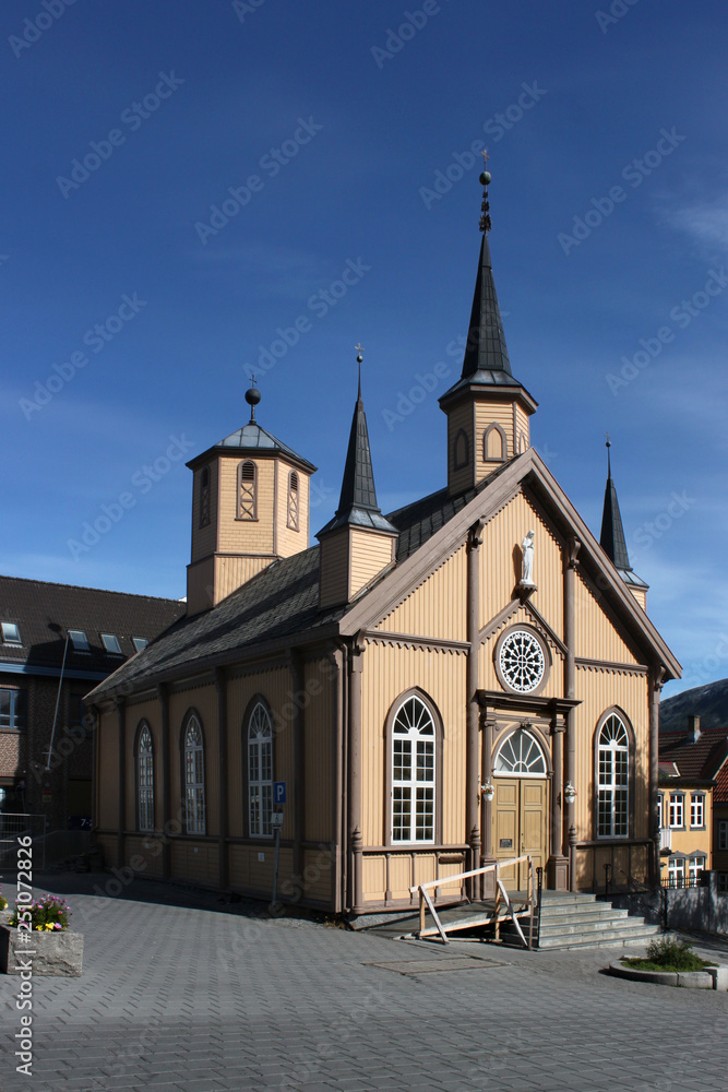 Front facade and northern side of the wooden neo-gothic Vår Frue Kirke in Tromso, Norway