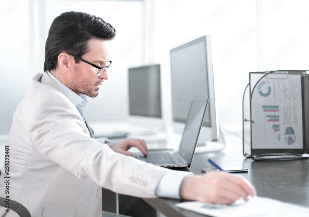 businessman writing down information in a notebook