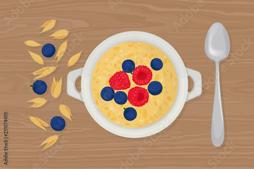 Porridge oats in bowl with spoon, berries, raspberry, nuts and cereals isolated on background. Healthy breakfast