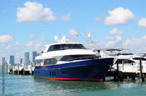 Blue and white motor yacht moored at a marina in Miami Beach,Florida