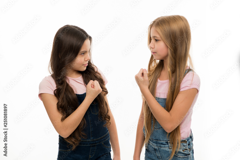 Who is the most beautiful. Small girls with long hairstyle showing their fists. Kids hair care and grooming. Competition with anger. Cute little girls wearing new hairstyle. Friendship break Who is the most beautiful. Small girls with long hairstyle showing their fists. Kids hair care and grooming. Competition with anger. Cute little girls wearing new hairstyle. Friendship break