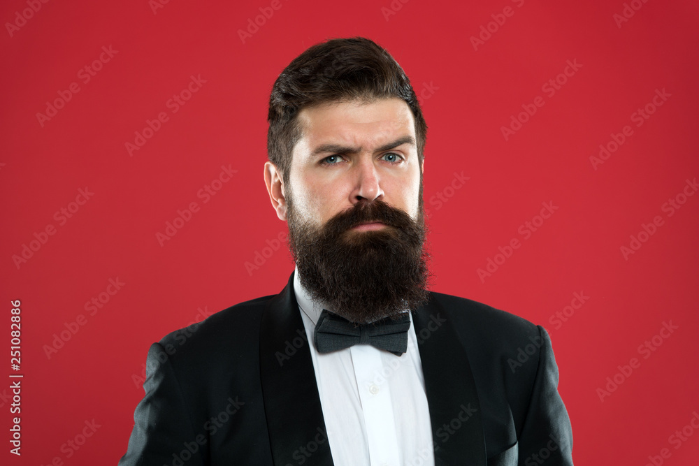 Classy style. Man bearded hipster wear classic suit outfit. Take good care of suit. Elegancy and male style. Businessman or host fashionable outfit on red background. Fashion concept. Formal outfit Classy style. Man bearded hipster wear classic suit outfit. Take good care of suit. Elegancy and male style. Businessman or host fashionable outfit on red background. Fashion concept. Formal outfit