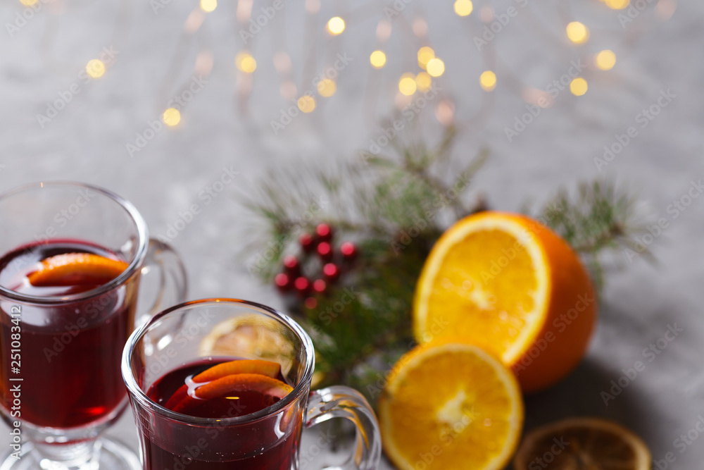 mulled red wine with spices and orange on dark background. warming drink mulled red wine with spices and orange on dark background. warming drink