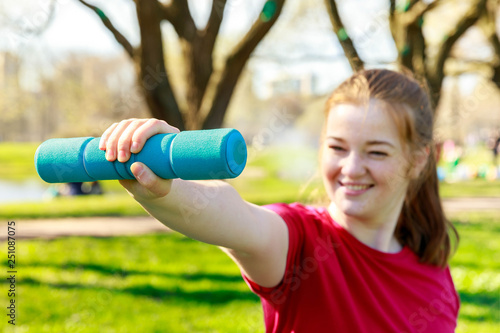 Woman workout summer training with the dumbbells Powerful, energy body