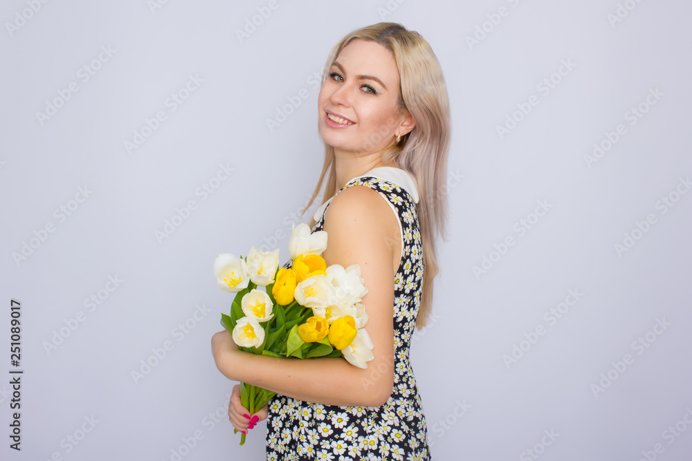 Blonde woman holding bouquet of tulips Blonde woman holding bouquet of tulips