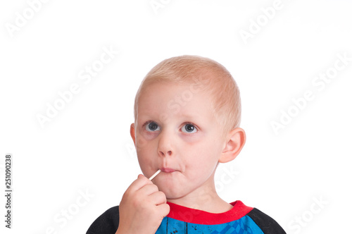 Litte boy eating candy