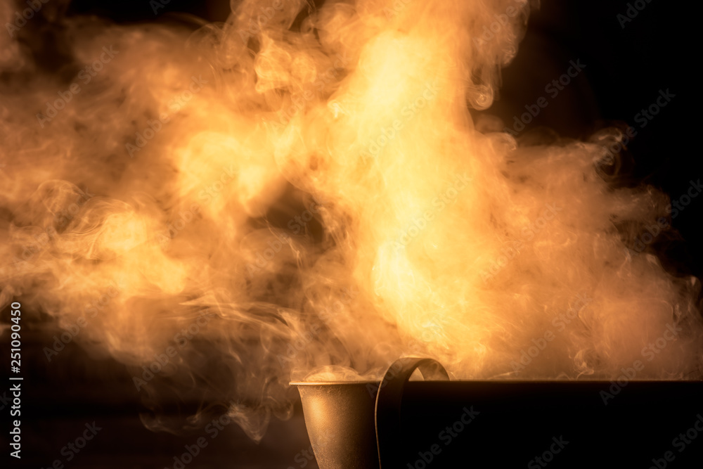incense burning in an ancient roman cauldron