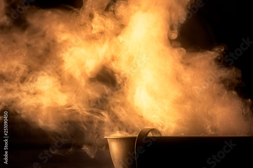 incense burning in an ancient roman cauldron