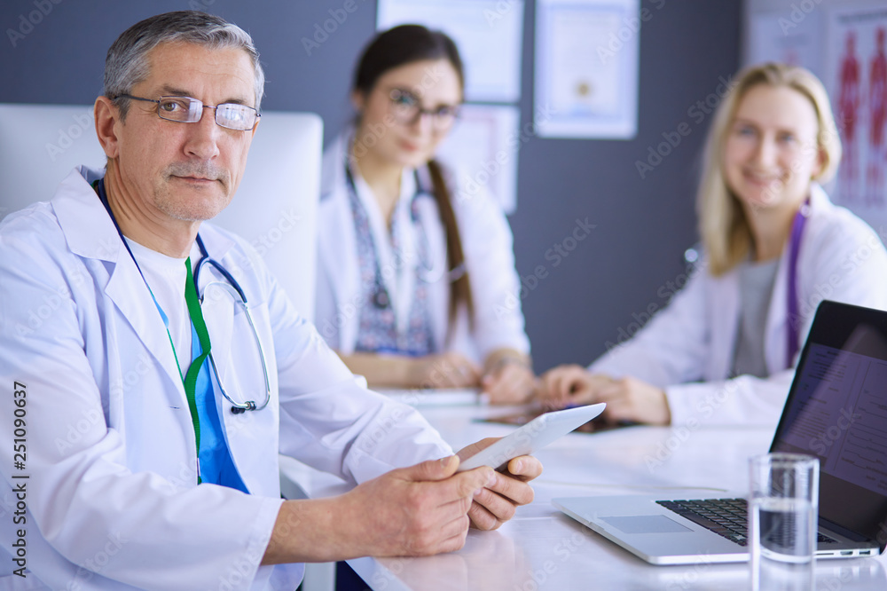 Doctor and patient discussing something while sitting at the table . Medicine and health care concept Doctor and patient discussing something while sitting at the table . Medicine and health care concept