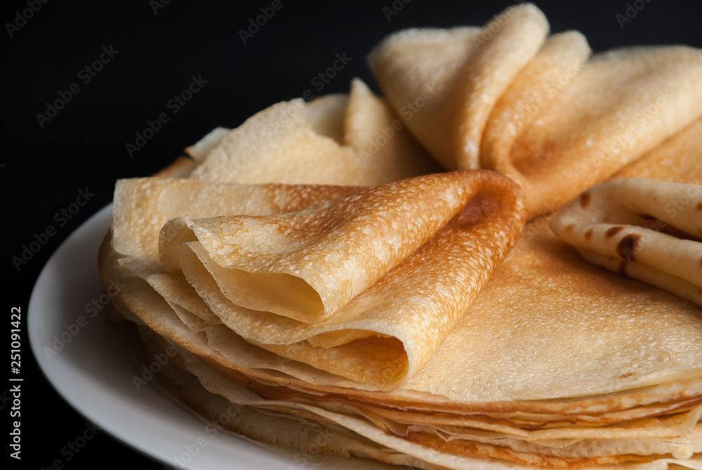 Pancakes, pancakes on a plate, dark background. Pancakes, pancakes on a plate, dark background.
