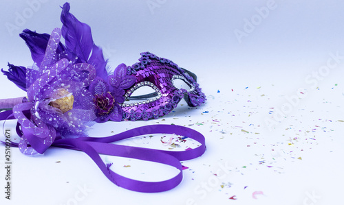 Violet masks on white background and violet flower and ribbon heart shape. Carnival or Carnival Sunday concept.