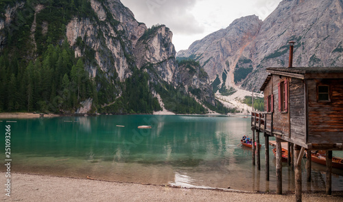 Lake of Braies, Italy. View of the lake with its famous pilework and tourists on a rowing boat