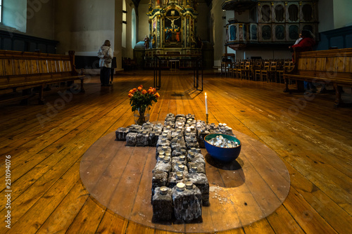 Votive candles on a cross inside Var Frue Kirke (Our Lady's Lutheran church), Trondheim, Norway photo