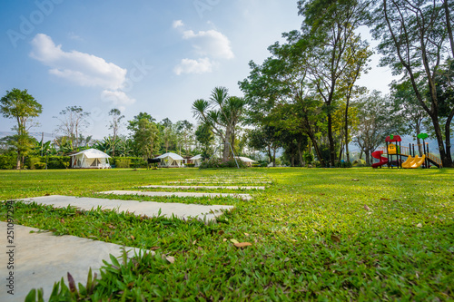 the footpath on green lawns and tent in the garden