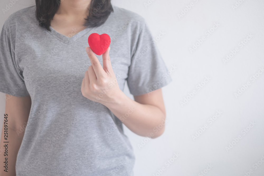 beautiful Asian woman show red heart isolated on a white background with copy space beautiful Asian woman show red heart isolated on a white background with copy space