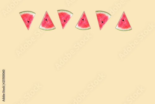 Slices of sweet fruit watermelon isolated on yellow background , Pastel color .
