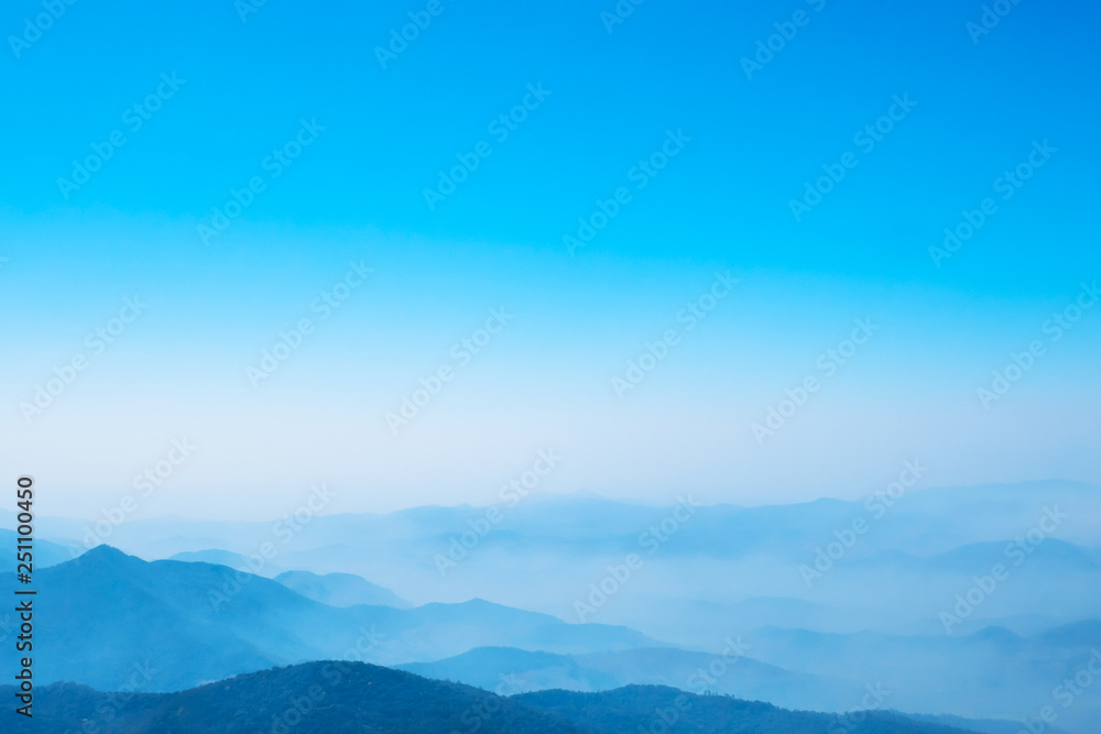 The mountains and forests with blue sky and white clouds at the peak of Inthanon national park (park name) in Chiang Mai province , Thailand in a foggy or misty day , real photo not graphic program.  