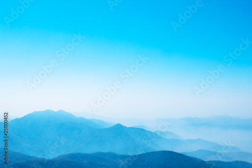 Fototapeta Naklejka Na Ścianę i Meble -  The mountains and forests with blue sky and white clouds at the peak of Inthanon national park (park name) in Chiang Mai province , Thailand in a foggy or misty day , real photo not graphic program.  
