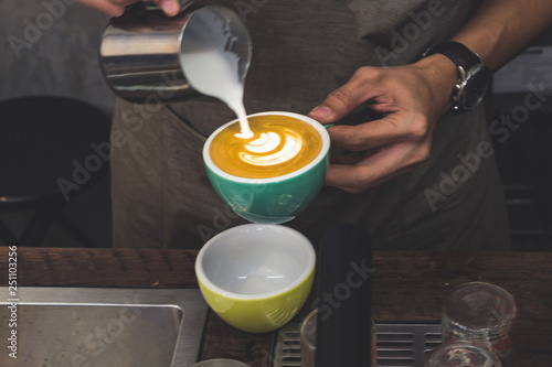 Coffee latte art in coffee shop in vintage color filter photo