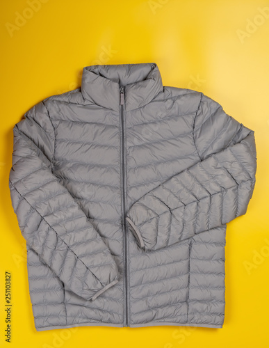 mens insulated down jacket with pockets on a yellow background