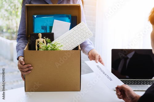 фотографія Closeup hand of business woman her is sending letter for resignation to boss in office