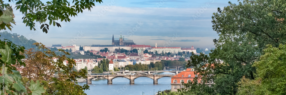 Fototapeta premium View of bridges, river, castle church in Prague, Czech Republic.