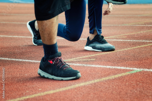 Sport and healthy lifestyle concept. croppe image of young sportsman standing over shallow depth of field background