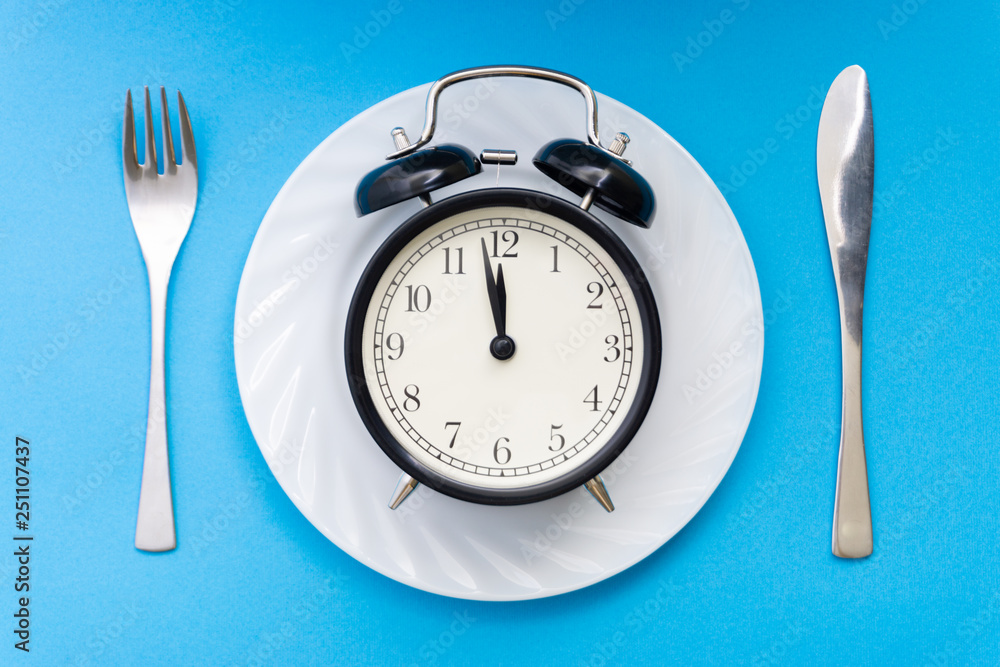 Alarm clock with fork and knife on the table. Time to eat, Breakfast, Lunch time and dinner concept. Alarm clock with fork and knife on the table. Time to eat, Breakfast, Lunch time and dinner concept.