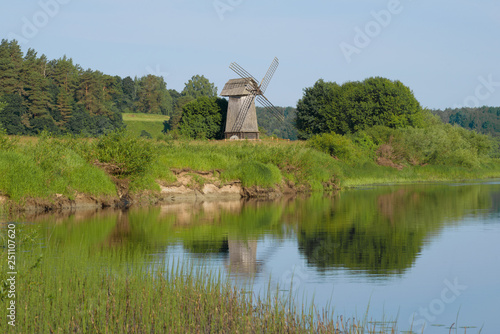 Old windmill on the bank of the river Sorot on the morning of June. Mikhailovskoe, Pushkin Mountains photo