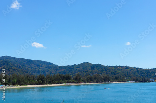 Blue sky and ocean in cleary day, have Phuket island with people on the beach