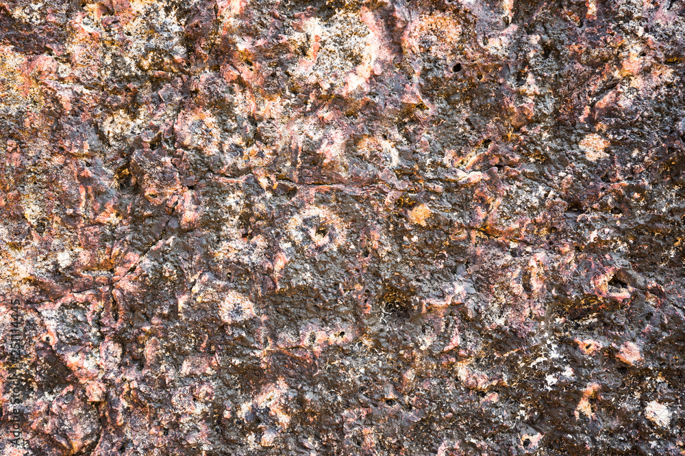 Dark purple stone texture with orange dots. Limestone background. Dark purple stone texture with orange dots. Limestone background.