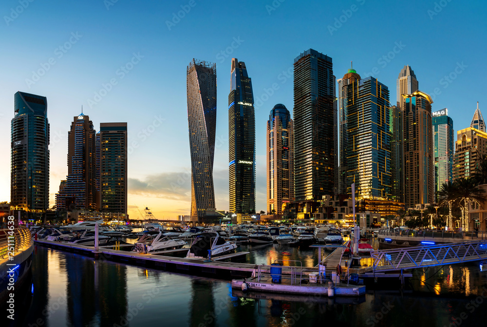 Dubai marina modern skyscrapers and luxury yachts at sunset