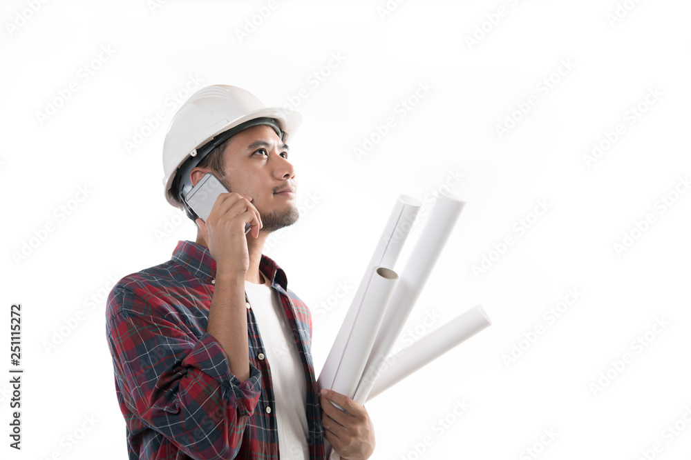 Portrait of asian engineer holding blueprint smiling and using a cellphone isolated on white background Portrait of asian engineer holding blueprint smiling and using a cellphone isolated on white background