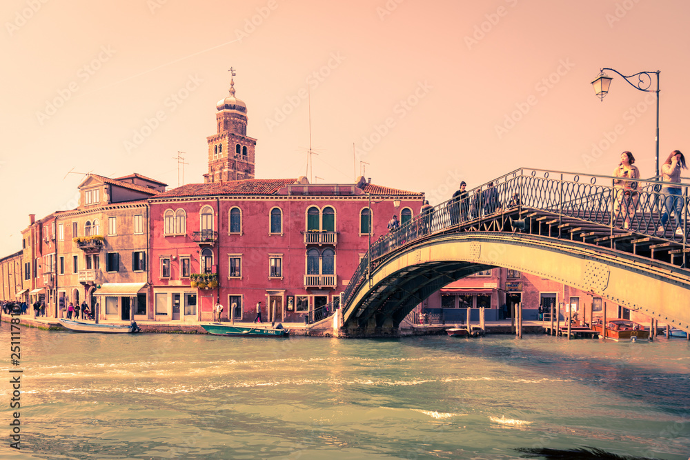 Historic buildings at sunset on the banks of the canal in Venice.