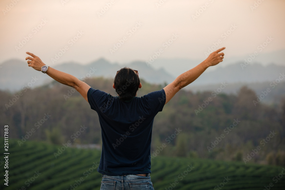 Freedom traveler men standing with raised arms and enjoying a beautiful nature and cheering young at sunset,Relax time on holiday concept travel Freedom traveler men standing with raised arms and enjoying a beautiful nature and cheering young at sunset,Relax time on holiday concept travel