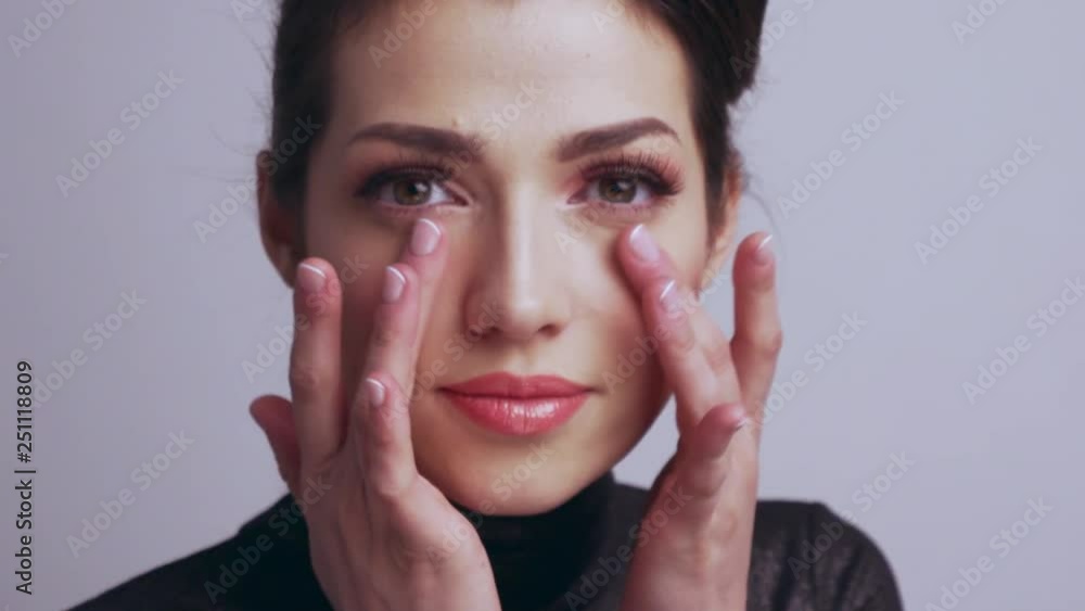 Beautiful woman touches skin of face. Caucasian adult girl cares of skin face. Beautiful brunette woman. Slow motion footage. Beauty treatment. Young woman touches her healthy face. Beautiful woman touches skin of face. Caucasian adult girl cares of skin face. Beautiful brunette woman. Slow motion footage. Beauty treatment. Young woman touches her healthy face.