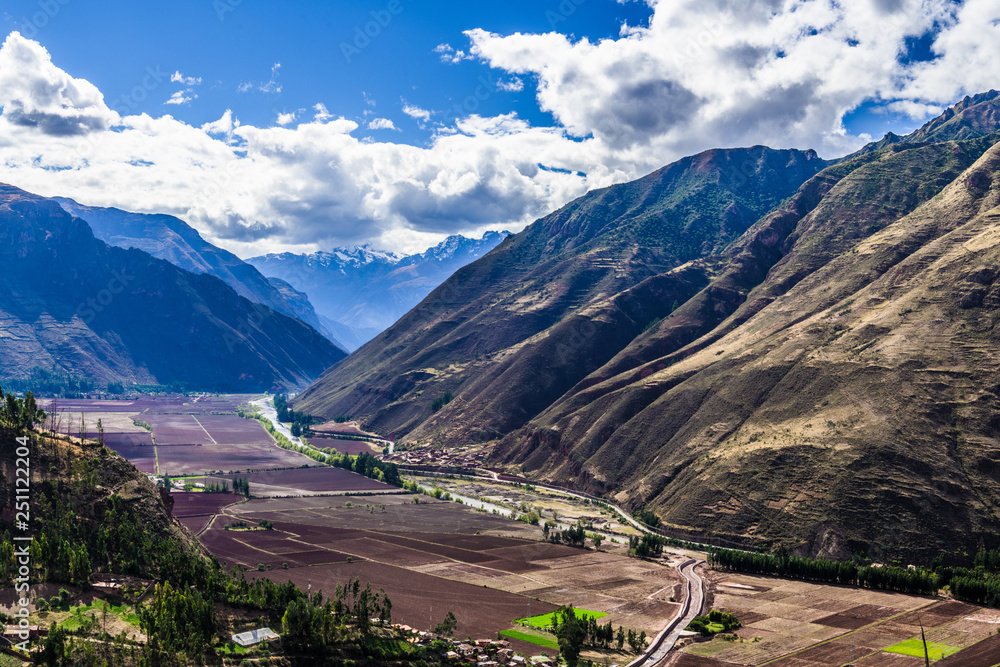 The road passes through the mountain valley in the Andes