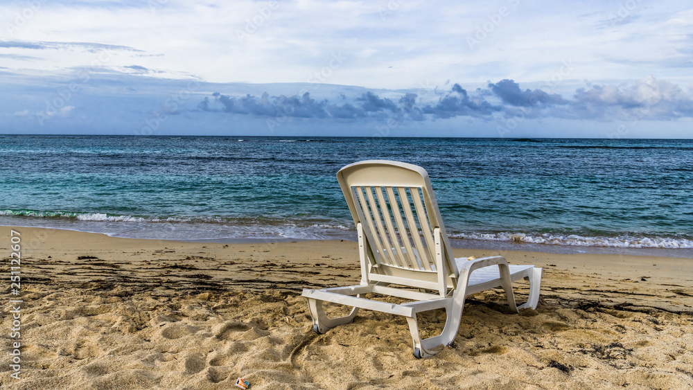 Chair on a deserted Caribbean beach