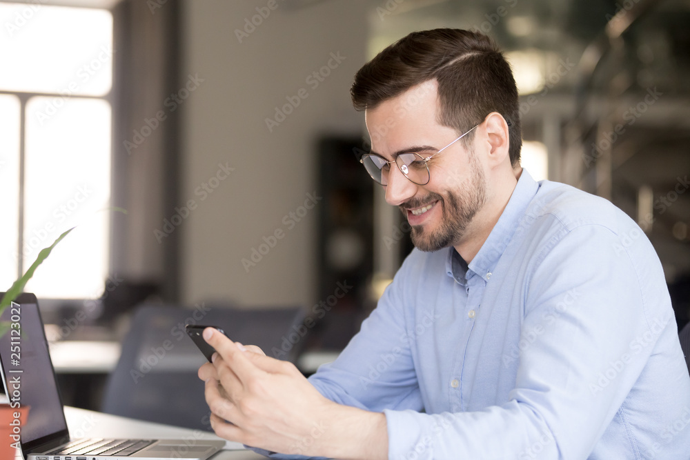 Happy businessman reading message looking at phone screen Happy businessman reading message looking at phone screen