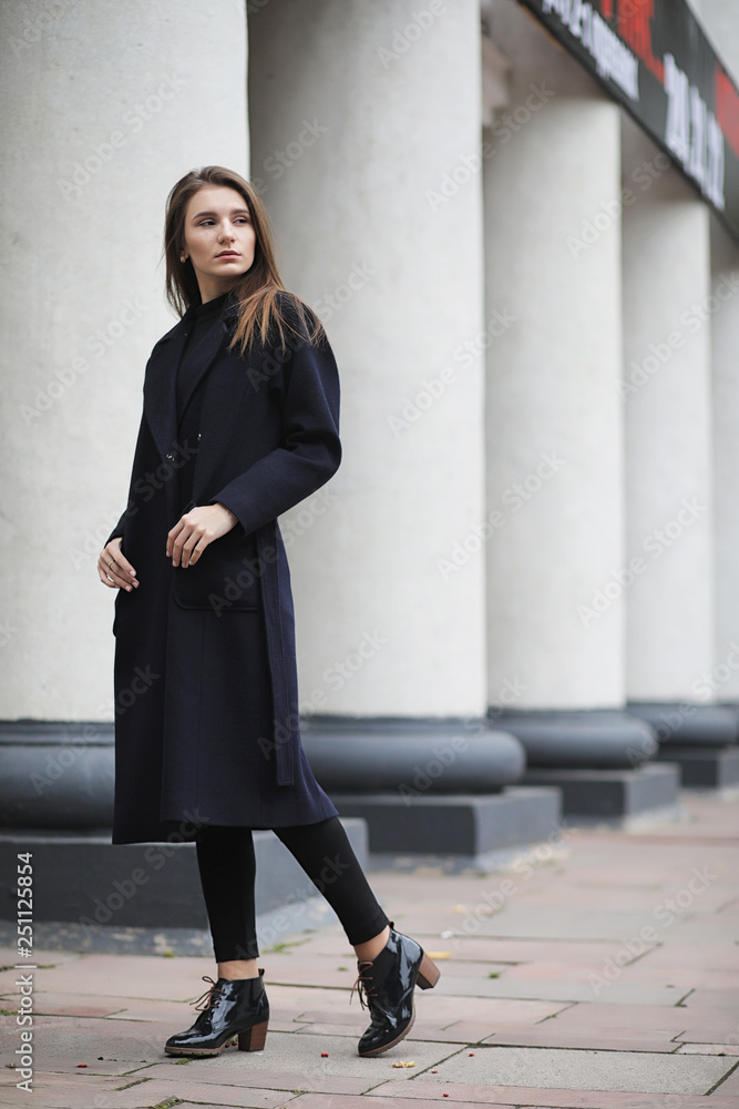 Beautiful girl in a coat in business downtown Beautiful girl in a coat in business downtown