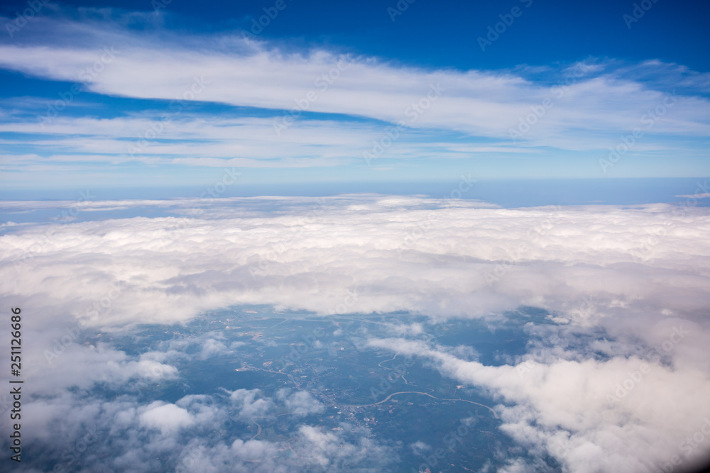 White cloud and blue sky at atmosphere Level, photo taken through the plane window White cloud and blue sky at atmosphere Level, photo taken through the plane window