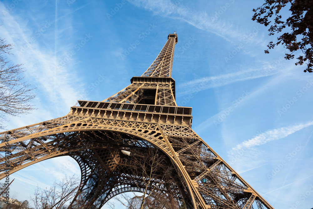 Wide shot of Eiffel Tower with blue sky in Paris - obrazy, fototapety, plakaty 