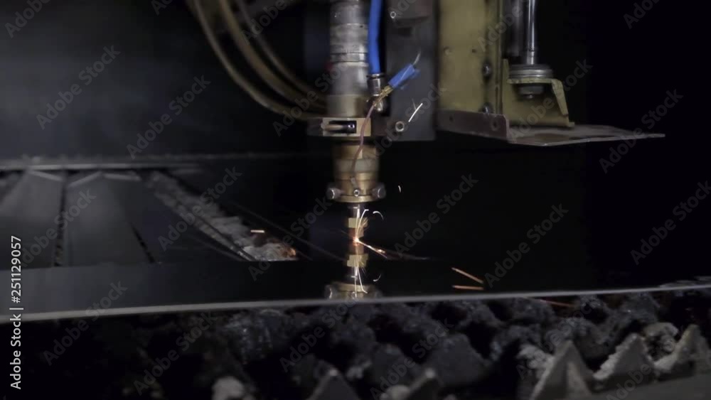 CNC Laser cutting of flat sheet metal steel material on a lathe with the program, modern industrial technology. bright sparks, and light. Industrial machine CNC plasma laser CNC Laser cutting of flat sheet metal steel material on a lathe with the program, modern industrial technology. bright sparks, and light. Industrial machine CNC plasma laser